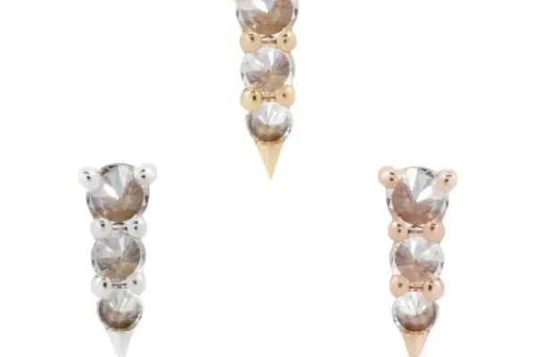 The 14K Bowery Reverse Set includes three pairs of stud earrings, each with two vertically stacked round clear stones ending in a pointed tip, set in silver, yellow gold, and rose gold toned metal.