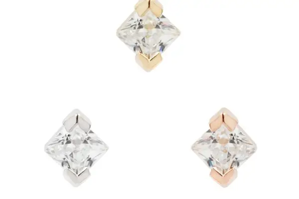 Three square-cut clear 14K Celestial - CZ gemstones are set in 14K gold (top), silver (left), and rose gold (right), arranged in a triangle on a white background.
