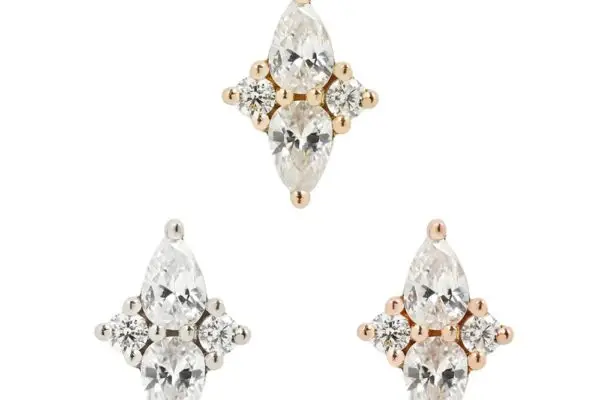 The 14K Ethereal - CZ set includes three stud earrings with marquise and round-cut CZ stones in a cross pattern—two in 14K gold, one in silver—for a luminous, elegant look.