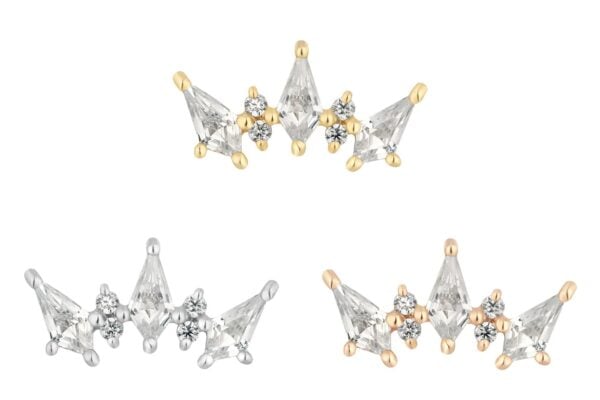 Three crown-shaped earrings—gold, silver, and rose gold—adorned with clear gemstones and floral accents are displayed on white. Each piece brings a touch of 14K Scandalous elegance to your style.