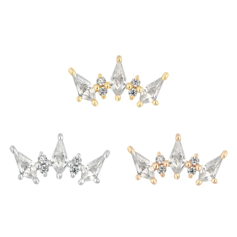 Three crown-shaped earrings—gold, silver, and rose gold—adorned with clear gemstones and floral accents are displayed on white. Each piece brings a touch of 14K Scandalous elegance to your style.