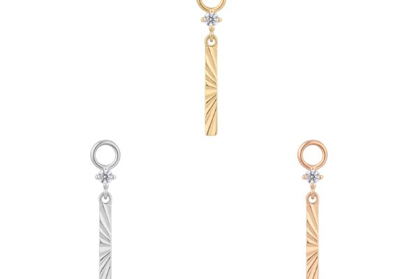 Three vertical bar pendants in gold, silver, and rose gold, each featuring a sunburst engraved pattern inspired by our 14K Labyrinth - Charm collection, with a circular gem above the bar and a loop for attaching to jewelry.