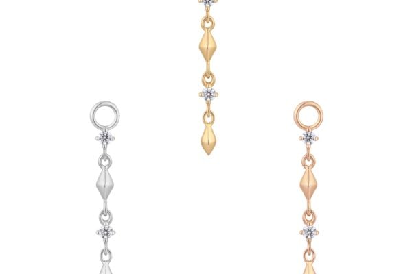 The 14K Ischia - Charm features three elegant dangling earrings in gold, silver, and rose gold, each accented with two diamond-like stones and geometric beads, beautifully presented on a white background.