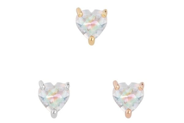 Three heart-shaped, iridescent rainbow moonstones are set in prongs—one 14K gold, one silver, one rose gold—showcasing the beauty of the 14K Rainbow Moonstone Heart on a plain white background.