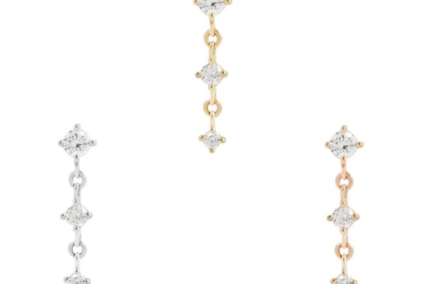 Three pairs of 14K Kiera Dangle End earrings, each featuring three linked clear gemstones, are displayed in silver, yellow gold, and rose gold finishes against a white background.