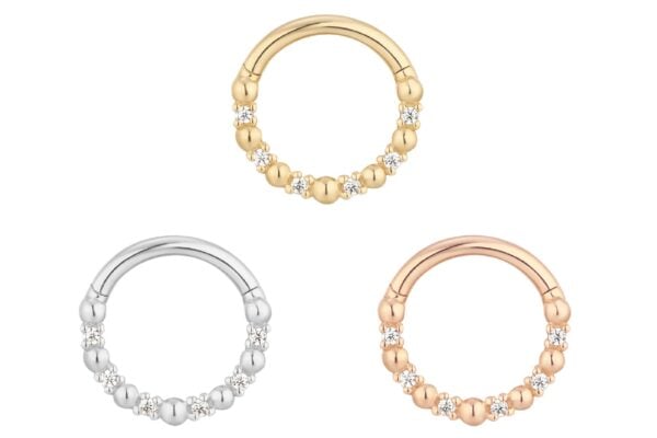 Three circular 14K Love Is Love - Clicker earrings are shown in gold, silver, and rose gold. Each earring features small bead accents and clear sparkling stones along the bottom half.