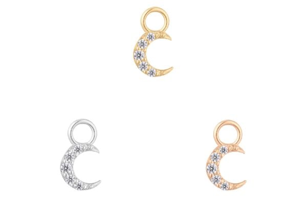 Three crescent moon charms, including the 14K Lunette - Charm embellished with clear gemstones, are arranged in a triangle on a white background. The charms display silver, gold, and rose gold tones.