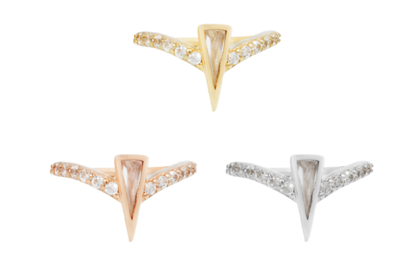 Three 14K Mikah - Clicker chevron-shaped rings with small embedded gems are shown on a white background: gold (top), rose gold (left), and silver (right).