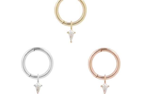 Three circular hoop earrings in gold, silver, and rose gold each feature a clear teardrop gem. Elegant with the 14K Mini Soho - Pendant, they are displayed separately on a white background.