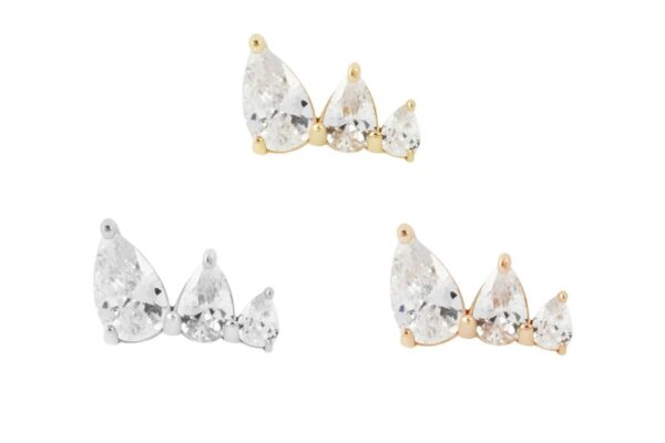 Three pairs of 14K Myriad stud earrings, each with three clear gemstones, are set in gold, silver, and rose gold tones and shine elegantly against a white background.