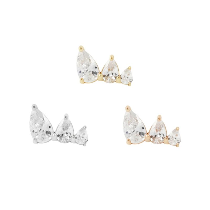 Three pairs of 14K Myriad stud earrings, each with three clear gemstones, are set in gold, silver, and rose gold tones and shine elegantly against a white background.