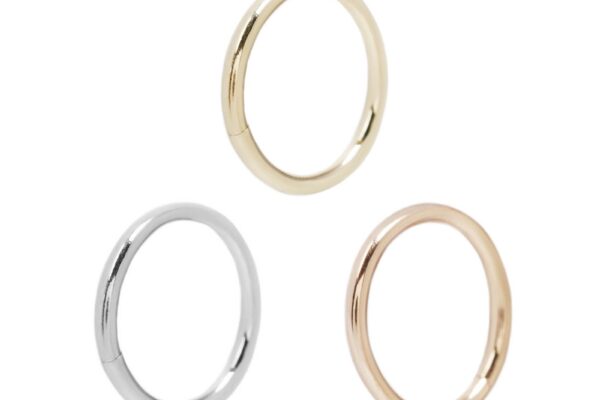 Three Solid Gold Seam Rings are displayed on a white background, each in a different color: yellow gold (top), white gold (bottom left), and rose gold (bottom right).