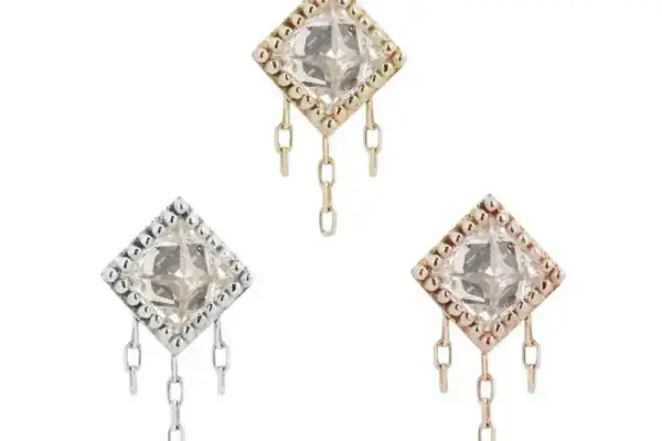 The 14K The Hustle earrings are square studs with a clear central gem, edged in silver, gold, or rose gold, and finished with two or three dangling chain links at the bottom.