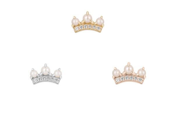 Three crown-shaped charms with pearl tops and sparkling gems in gold, silver, and rose gold highlight the elegance of the 14K The Vow collection against a white background.