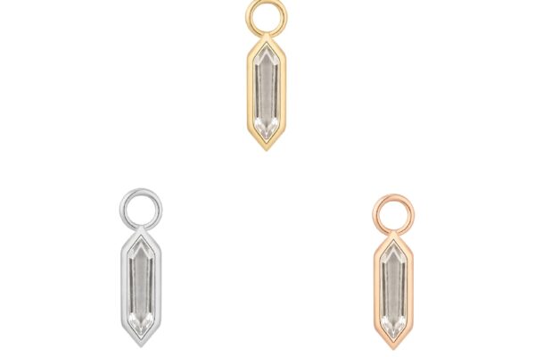 Three crystal-shaped pendants outlined in metal—a 14K Theory - Charm (top), a silver (bottom left), and a rose gold (bottom right)—are arranged in a triangle on a white background.