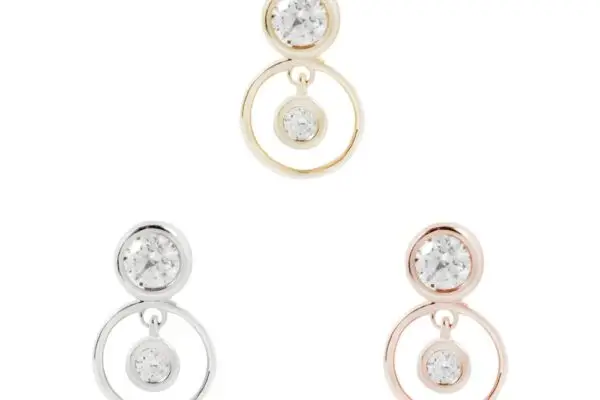 The 14K Warhol stud earring set features three pairs, each with a small bezel-set circular CZ linked to a larger open circle with a matching stone. Available in gold, silver, and rose gold tones.