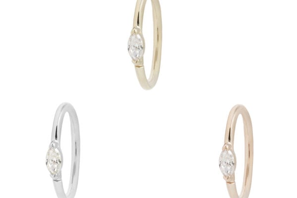 Three Zuri - CZ - Seam Rings are displayed on a white background: one in yellow gold, one in white gold, and one in rose gold, each featuring a single round cubic zirconia in a bezel setting.
