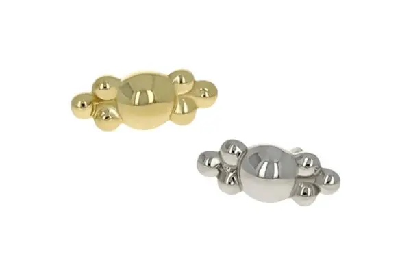 Two oval-shaped metal objects—one in 18k gold, one in silver—with three small round extensions on each side, set against a plain white background to highlight the sleek design of the 18k Desta End 2.