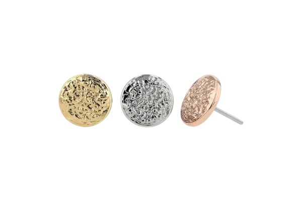 Three 14k Textured Disk End earrings in gold, silver, and rose gold are shown against a white background. Each features an intricate filigree floral design.
