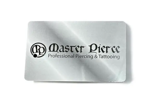 The Master Pierce Gift Card is a metallic card featuring a shiny, reflective surface with the black Master Pierce Professional Piercing & Tattooing logo and text.