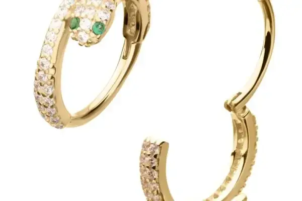 The 14K Snake Eye Clicker - Emerald are gold hoop earrings shaped like snakes, adorned with clear stones and featuring emerald-green eyes. One earring is open to show the clicker clasp mechanism.