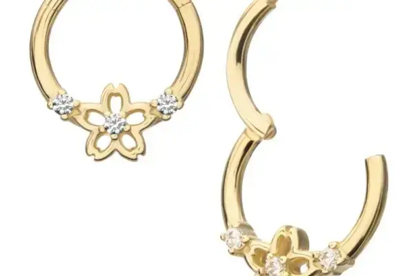 The 14K Cherry Blossom Clicker hoop earrings feature delicate cherry blossom designs with sparkling clear stones and a secure clasp shown both open and closed. Crafted in 14K gold.