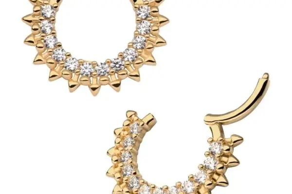 The 14K 12 Spiked Gem Clicker earrings feature a pair of gold hoops with 12 spiked gem accents and a row of clear stones along the front, displayed against a white background.