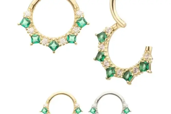 Set of four hoop earrings with green gemstones and clear crystals in gold and silver finishes. One is shown open to reveal the 14K Princess Clicker - Emerald, highlighting its secure clasp. Displayed on a white background.