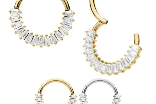 Four hoop earrings—two gold, two silver—each embellished with a row of clear baguette gemstones along the lower half. One gold earring is open to display the 14K Baguette Clicker clasp mechanism.