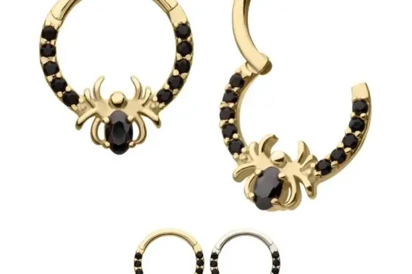 The 14K Spider Clicker features hoop earrings with bold spider motifs and sparkling black gemstone bodies. Shown in gold, silver, and rose gold, each pair showcases striking black stone accents for a unique statement look.