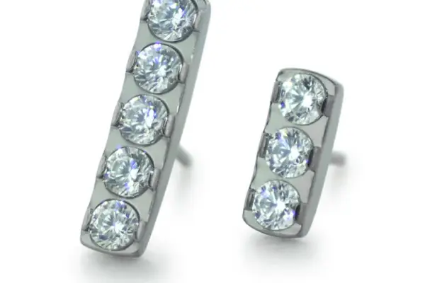 A pair of mismatched silver Gem Bar Ends stud earrings, each featuring three round, clear gemstones set vertically; one earring is slightly longer than the other.