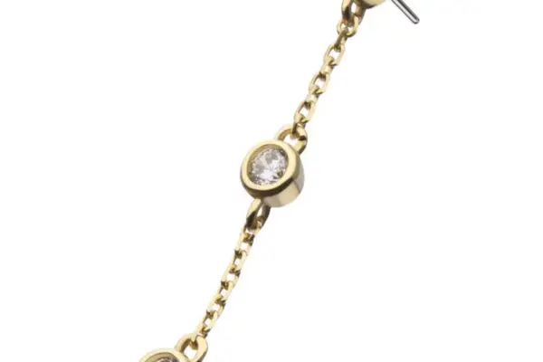 The 14K Triple Bezel Gem - Dangle earring showcases three round clear gemstones in bezel settings, linked by a delicate gold chain and displayed against a white background.