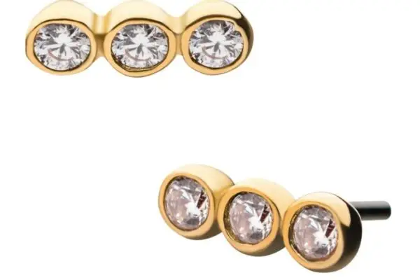 The 14K 3 Tier Bezel stud earrings feature three round clear gemstones in a horizontal row, each surrounded by a 14K gold bezel for an elegant, minimalistic look.