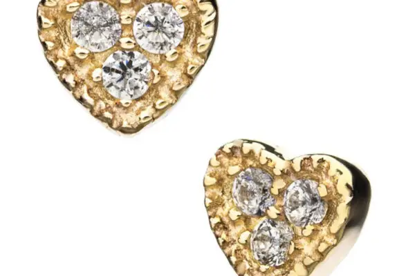 Add a charming accent to any look with the 14K Heart Triple Gem: heart-shaped 14K gold studs, each featuring a sparkling trio of diamonds in a textured setting.