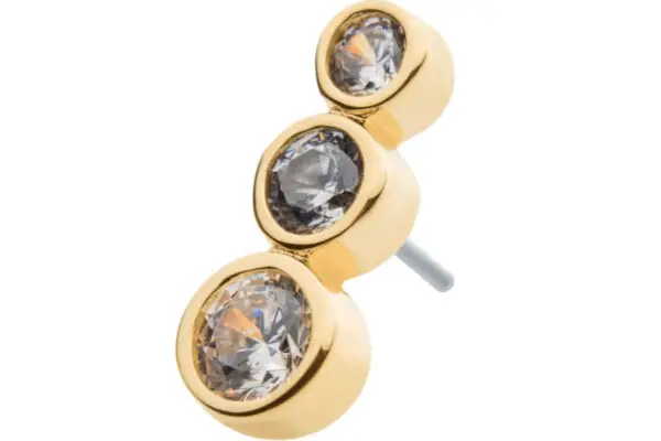 The 14K Triple Gradient Cluster is a gold stud earring with three round, clear gemstones in different sizes arranged vertically.