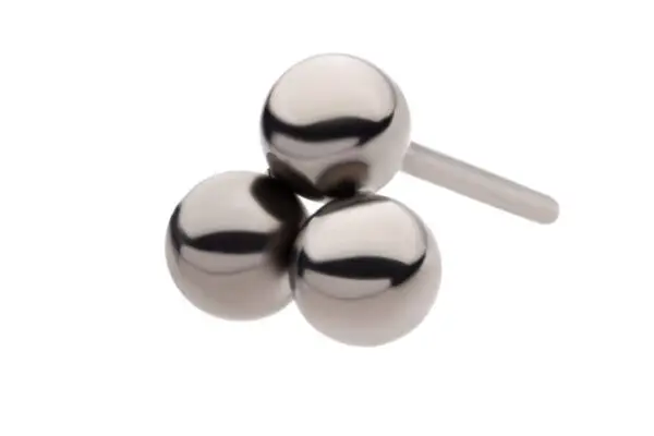 The Trinity Beads earring stud showcases a minimalist design with three polished metal spheres clustered together, crafted in titanium and presented on a plain white background.