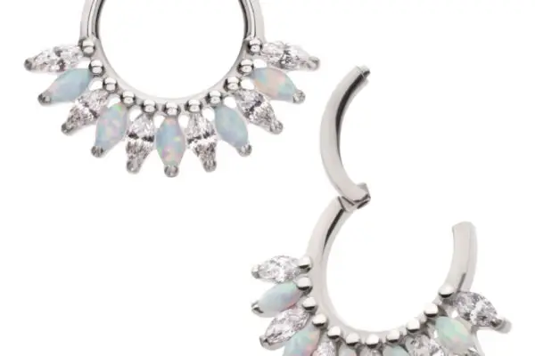 The Marquise Fan Clicker is a pair of silver hoop earrings with alternating marquise-shaped opal and clear gemstones along the bottom edge; one earring is shown open, the other closed.