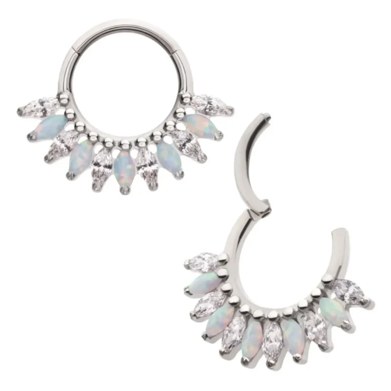 The Marquise Fan Clicker is a pair of silver hoop earrings with alternating marquise-shaped opal and clear gemstones along the bottom edge; one earring is shown open, the other closed.