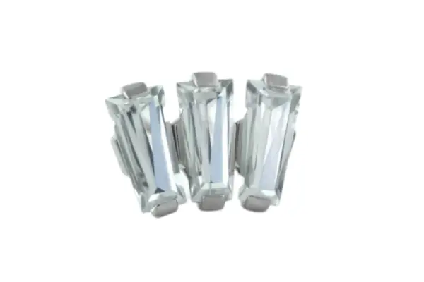 Three clear rectangular baguette-cut gemstones, upright and closely aligned on a white background, create the striking Titanium Baguette Cut Gem Fan Cluster.