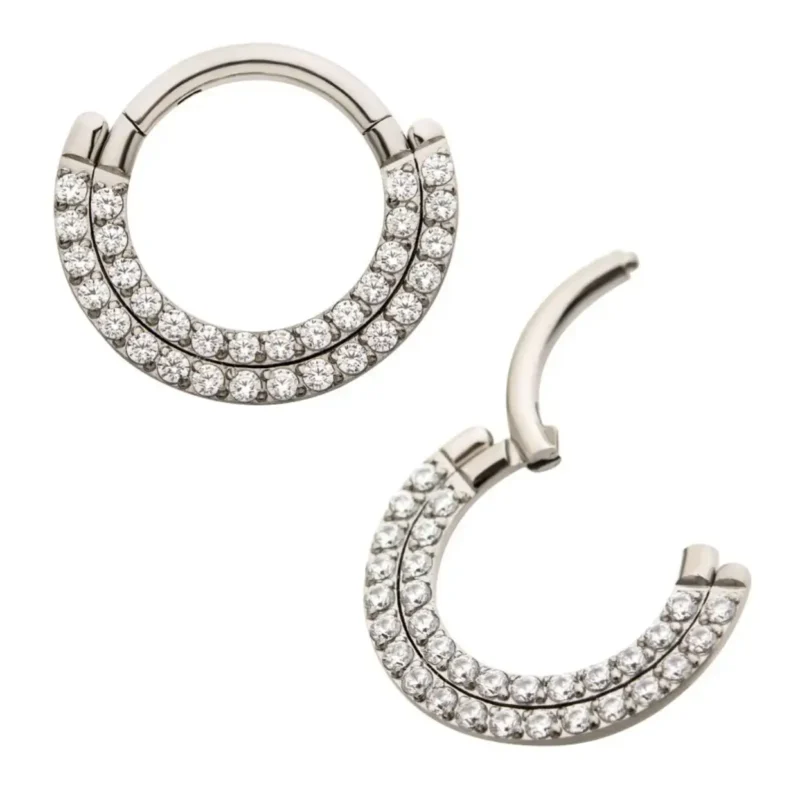 A pair of Double Row Prong Clicker hoop earrings in silver titanium, featuring two rows of clear gemstones; one is shown closed, the other open, on a white background.