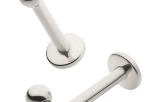 Two Basic Labret with Bead - Threaded studs are shown: one fully assembled and the other with its bead unscrewed to reveal the threaded post. Each features a flat disk on one end and a bead on the other.