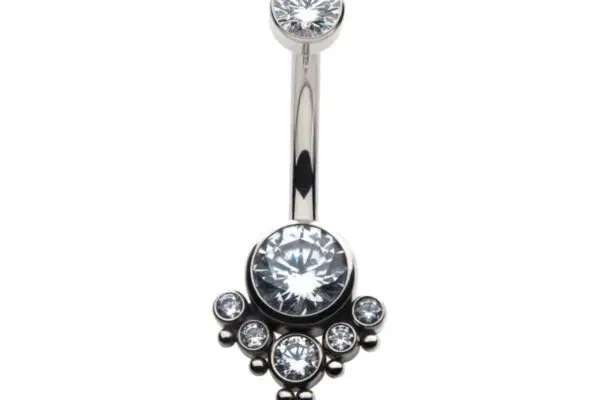 The Tri-Bead 6 Gem Navel features a silver belly button ring with a large central clear gem, five smaller surrounding gems in a decorative pattern, and an additional clear gem at the top—all crafted from titanium.