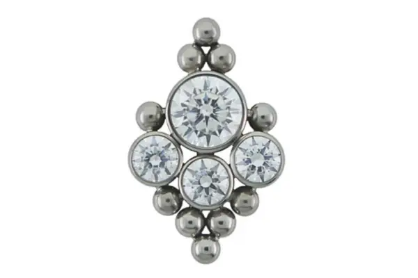 The 6HT-10 is a titanium jewel with a large central clear gem, three smaller surrounding gems, and six metal beads arranged in a symmetrical diamond-shaped design.