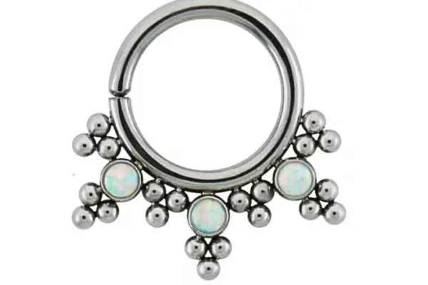 The HSMR-C is a titanium seam ring with a silver septum design, adorned with three opal-like gems and decorative metal bead clusters hanging at the bottom.