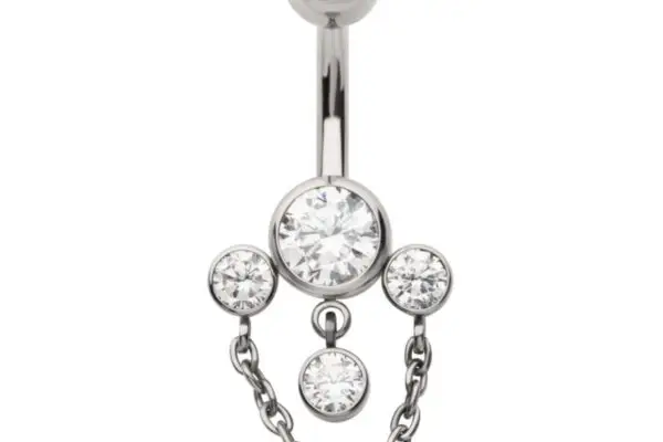 The Triple Gem Dangle is a titanium belly button ring with a large central gem, two smaller side gems, a dangling lower gem, and two delicate chains connecting the side gems for extra sparkle.