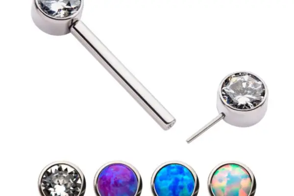 The Bezel Set CZ/Opal Fixed End includes five titanium interchangeable earring tops with silver settings: one clear gem, two blue stones with purple highlights, one mainly blue stone, and one orange-blue stone, plus a silver bar for attachment.