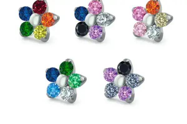 Flowers - Pride: Five pairs of titanium floral earrings inspired by Pride, Gender Fluid, Lesbian, Gay Man, and Asexual flags. Each pair features flag colors below the design.