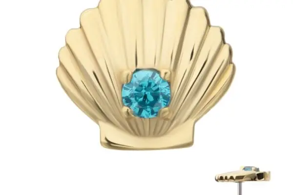 The 14K Seashell is a gold stud earring with a round blue gem at the center. Its side view shows a thick profile and a straight post for secure fastening.
