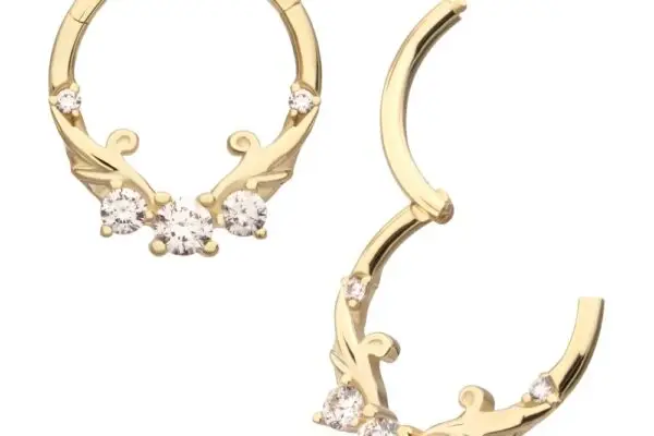 The 14K Swirled Vine - Clicker earrings are gold hoops featuring delicate vine and leaf designs, each adorned with three round white gemstones clustered at the front.