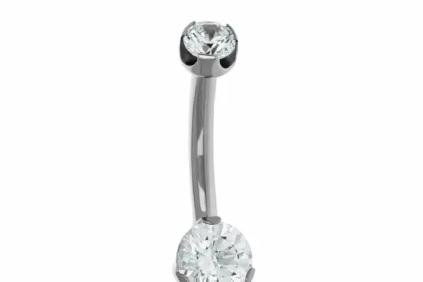 The Round Prong is a titanium navel curve barbell with a small clear gem on top and a larger clear gem on the bottom, both set in metal prongs, shown against a white background.